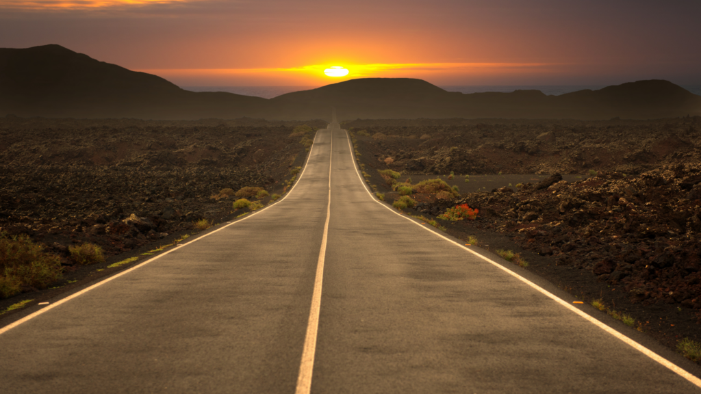 An empty road leading to a sunset, symbolises the road to data leadership